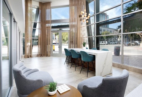 A modern office space with a table, chairs and a view of the street outside.