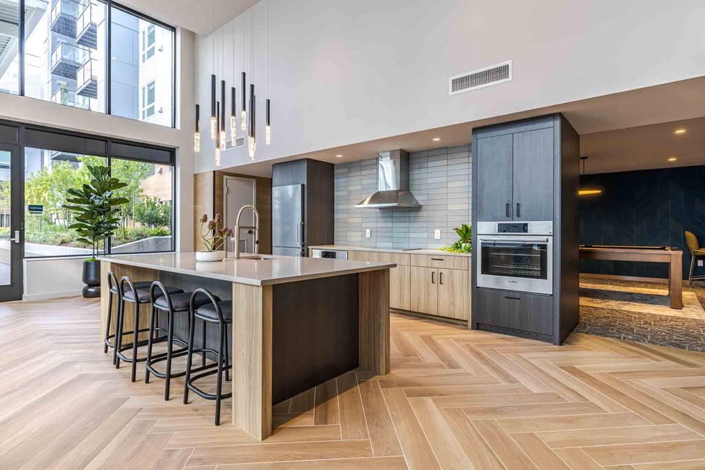 A modern kitchen with a large island and bar stools.