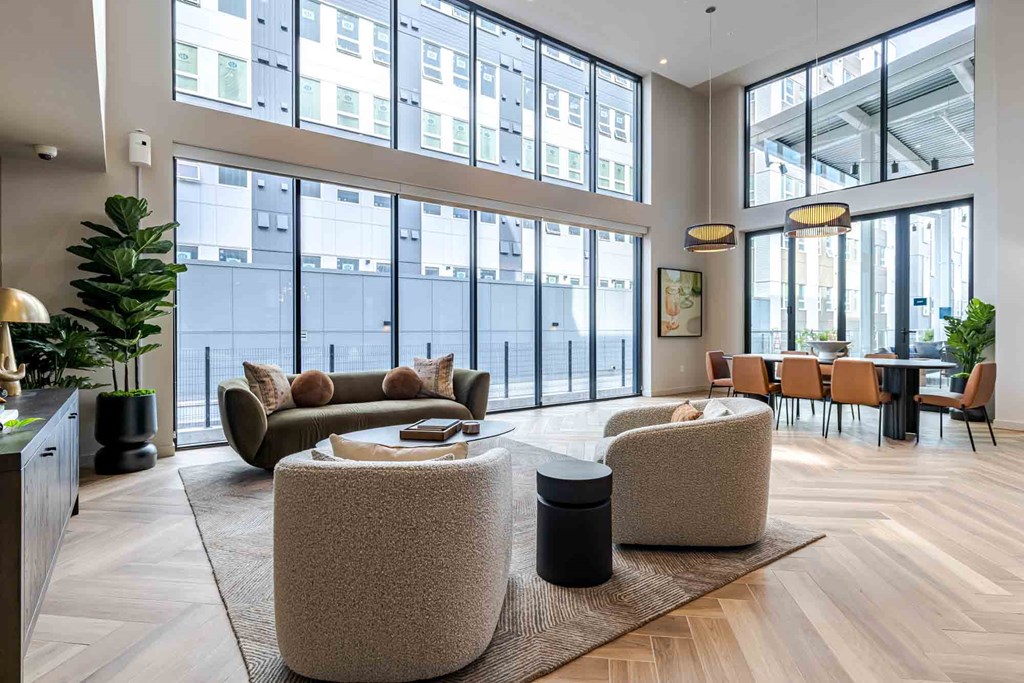 A modern living room with a large window and a view of the city.