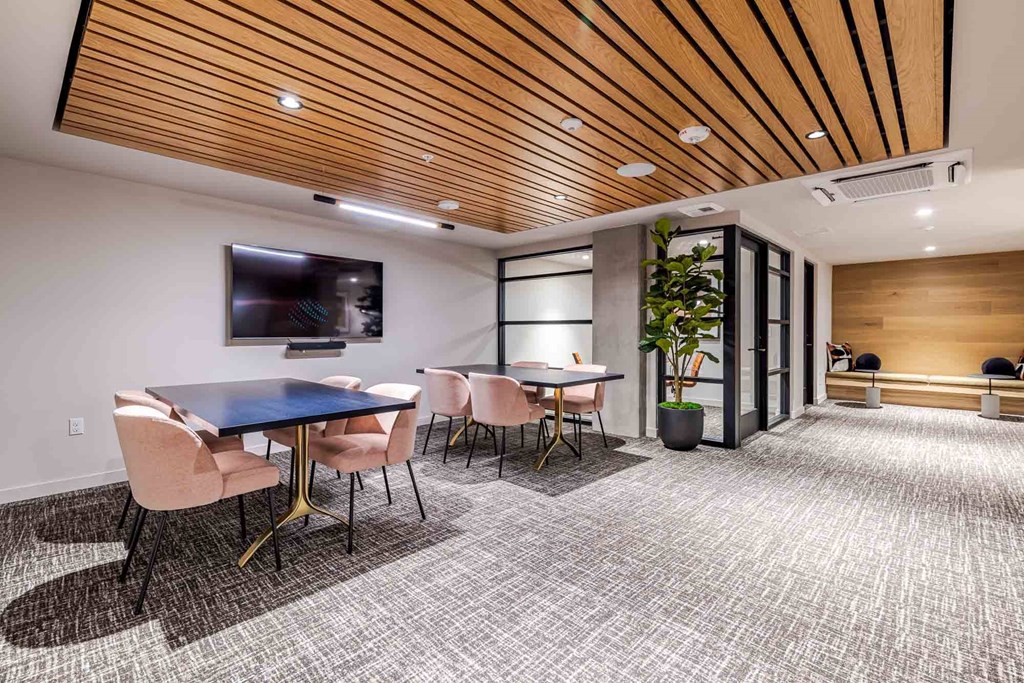 A conference room with a long table and chairs.