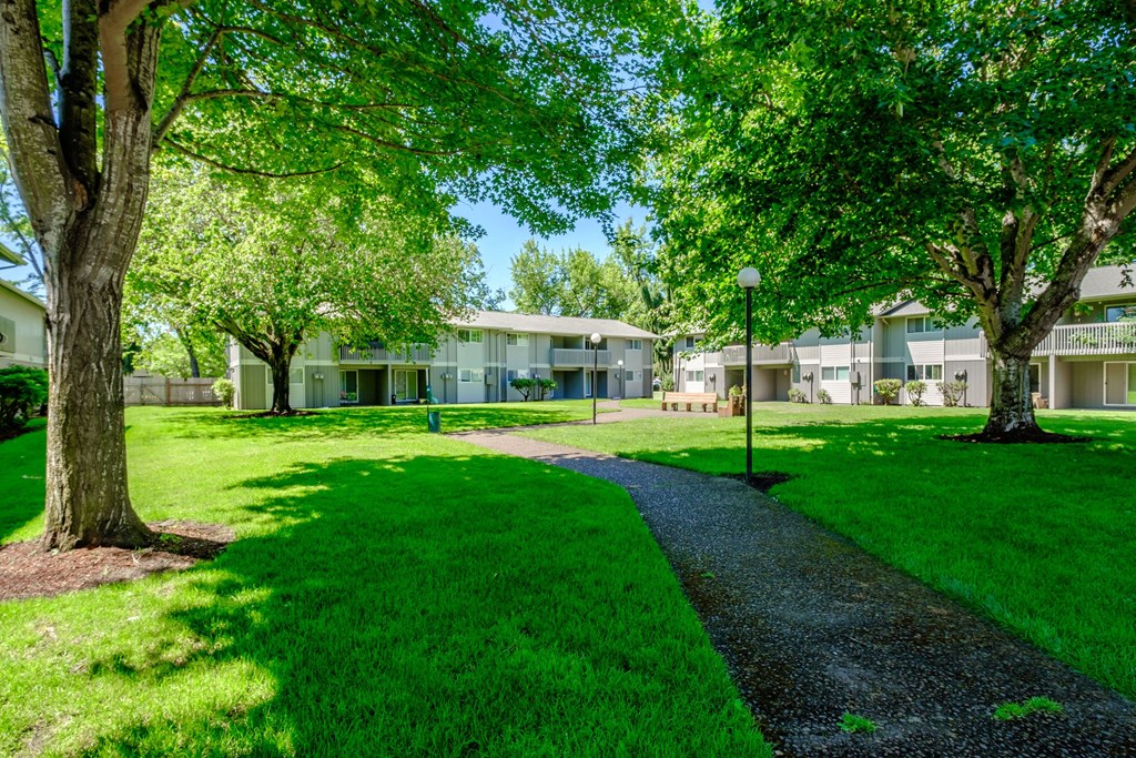 take a stroll through the grassy area at the Sequoia apartments in Springfield, Oregon