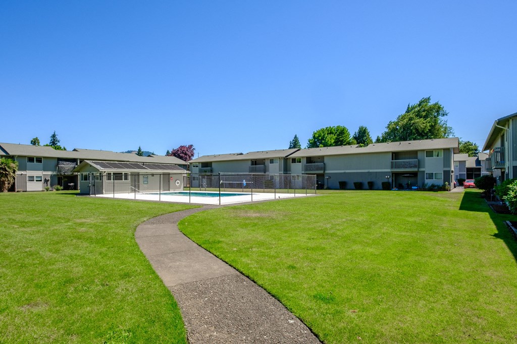 a view of a building with a swimming pool in front of it