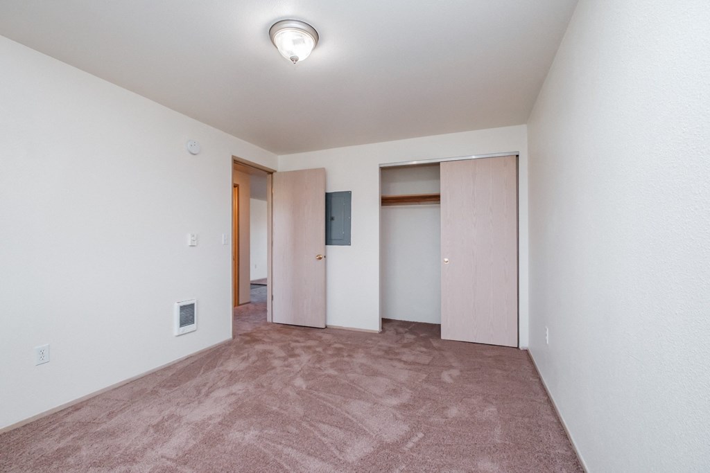a bedroom with a carpeted floor and white walls