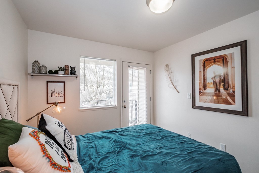 a bedroom with a bed and two windows