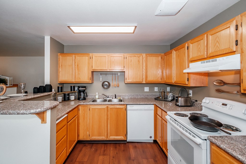 a kitchen with wooden cabinets and granite countertops