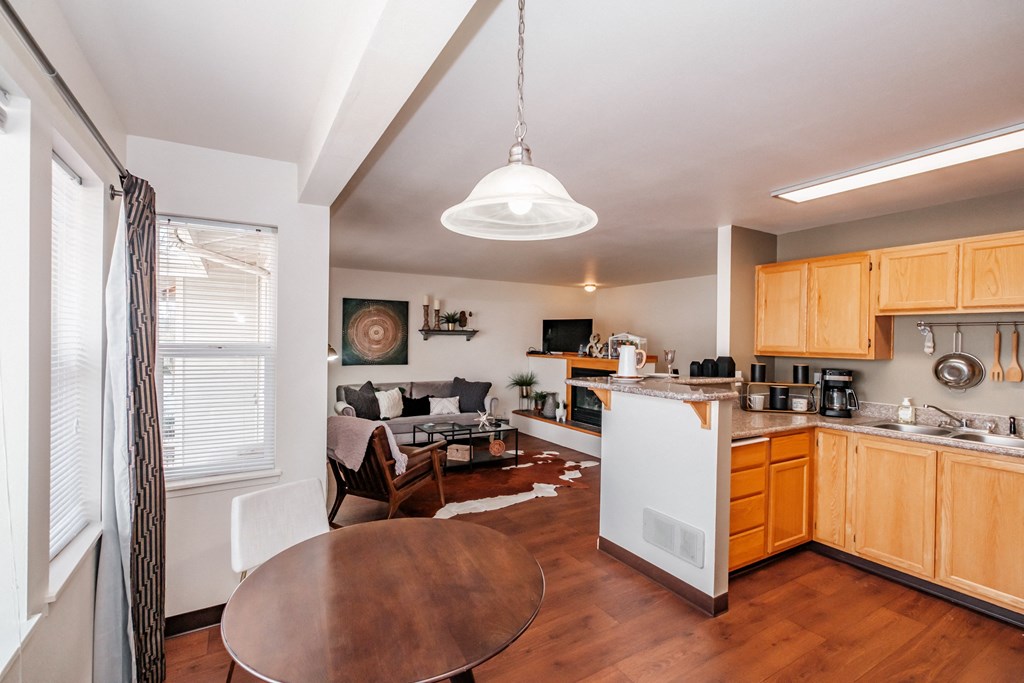 a kitchen and living room with wood floors and white appliances