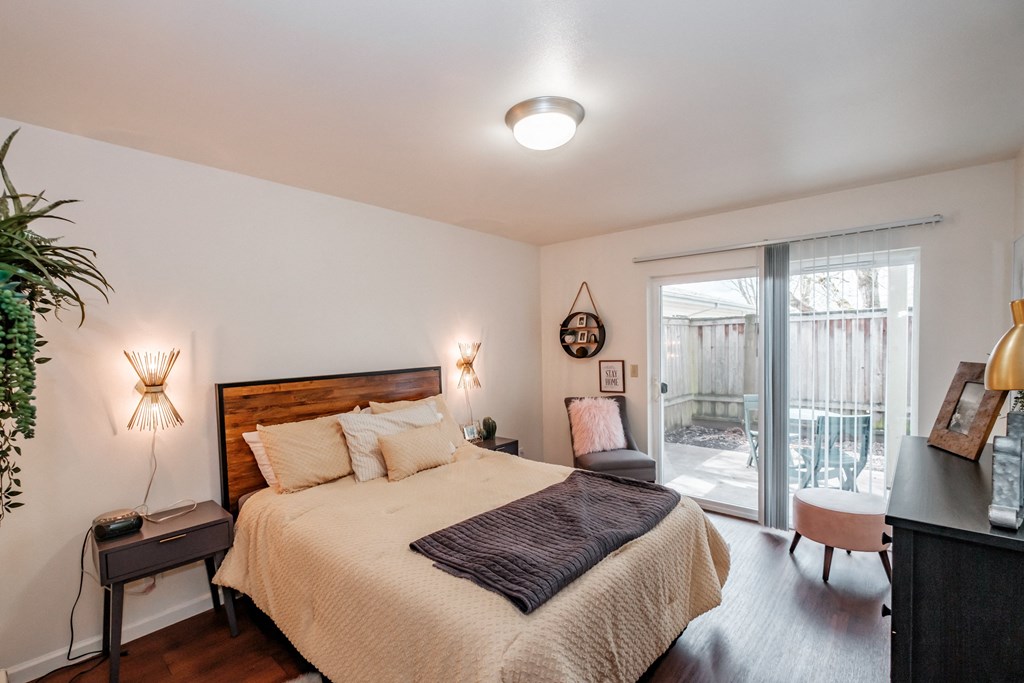 a bedroom with a bed and a sliding glass door