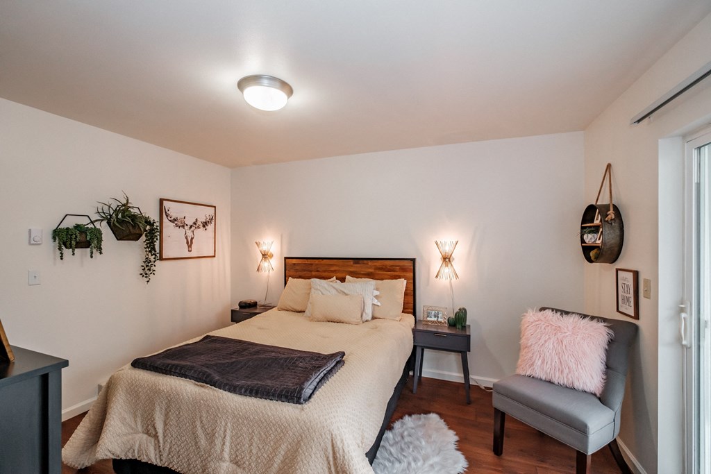 a bedroom with a bed and a chair