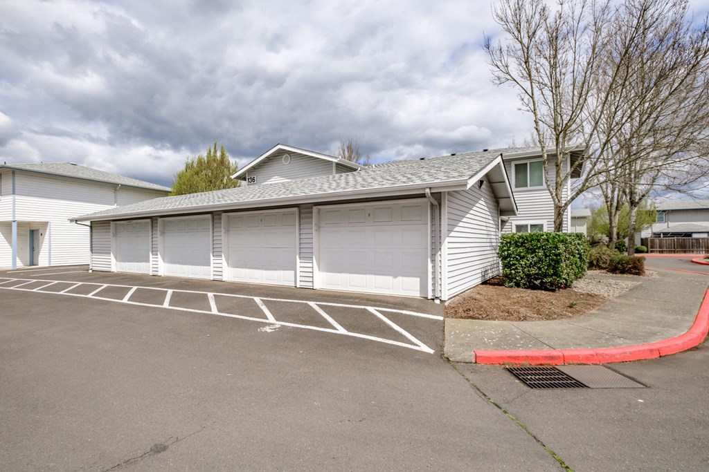 a garage with a carport in front of a house
