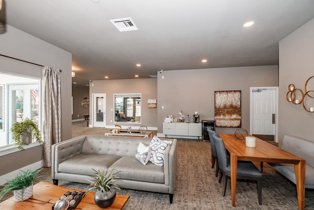 a living and dining room area with a couch table and chairs