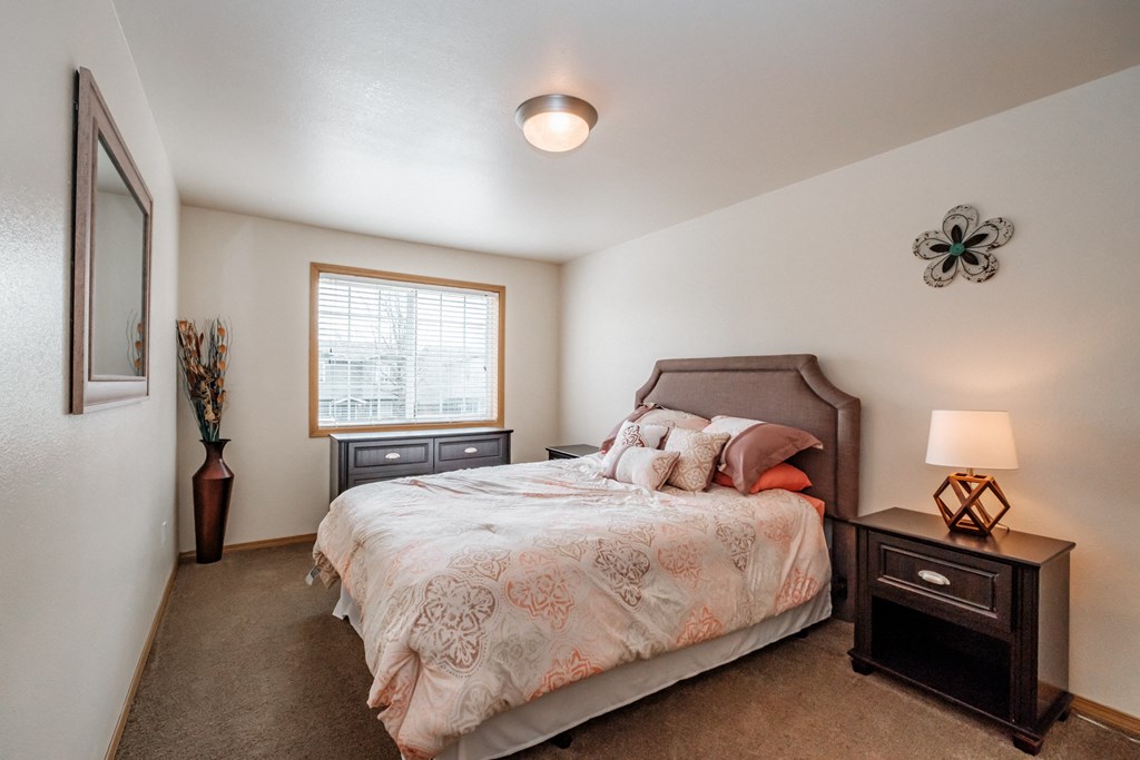 a bedroom with a bed and two night stands