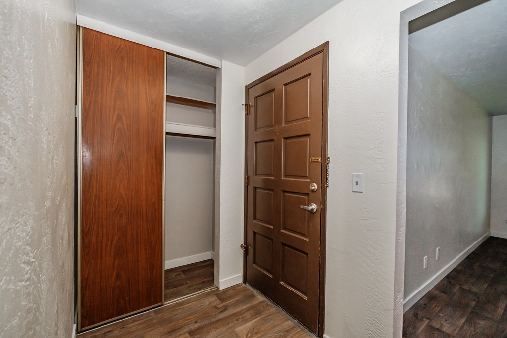 a bedroom with a closet and a door that is open