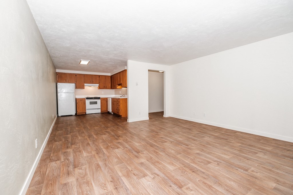 a bedroom with a medium hardwood floor and white walls