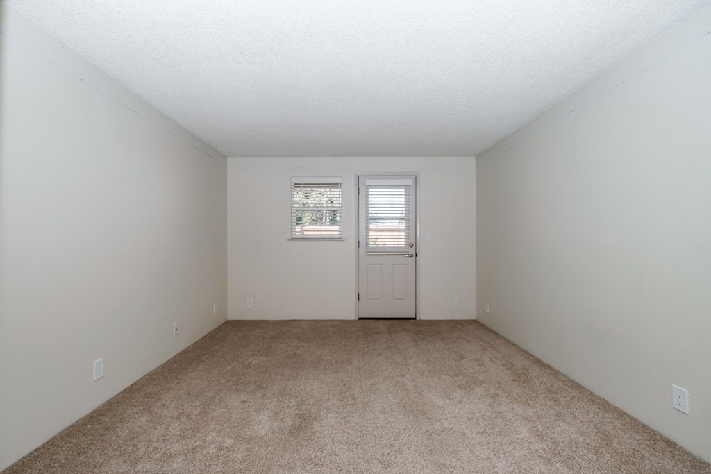 a bedroom with a carpeted floor and white walls