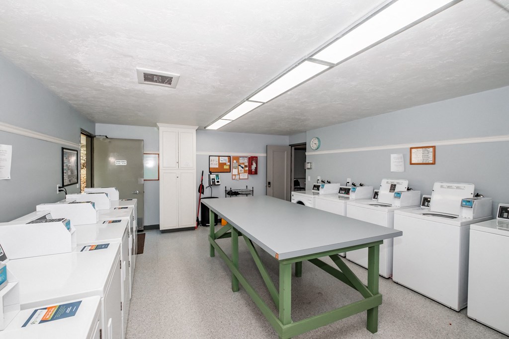 a room with a table and washing machines