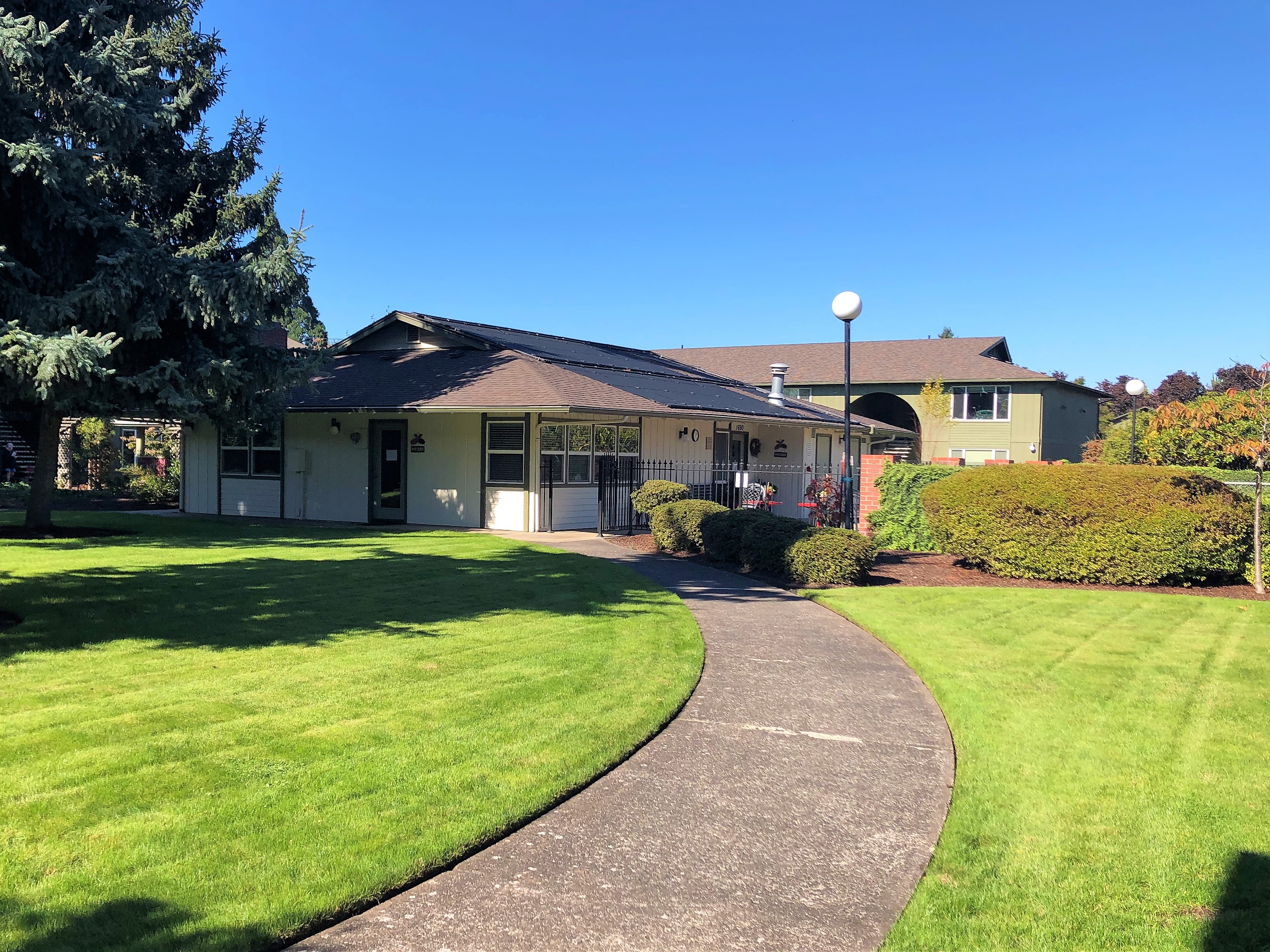 The Clairmont Apartments Building Exterior and Pathway with Landscaping