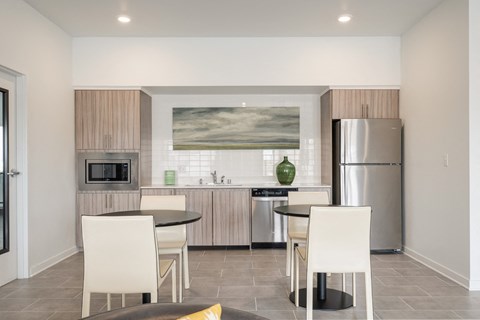 a kitchen and dining room with stainless steel appliances and a table and chairs