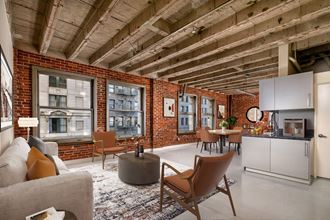 a living area with exposed ceilings and brick walls