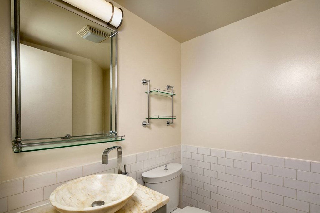 a bathroom with a sink toilet and mirror