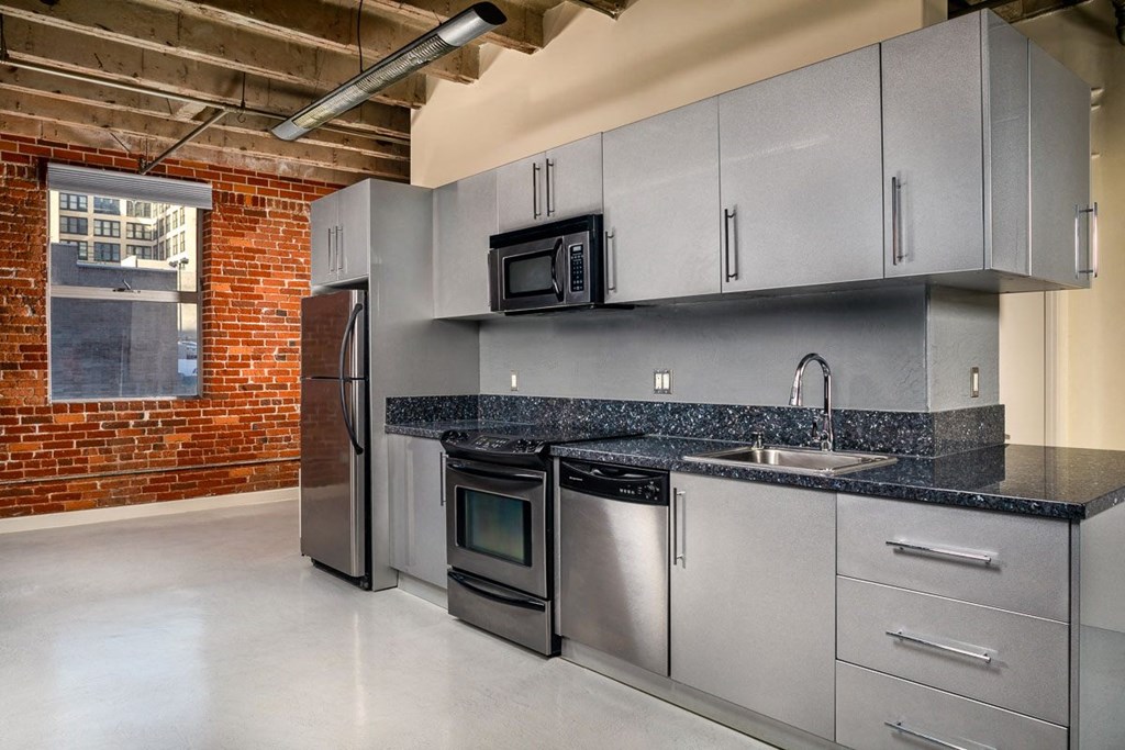 a kitchen with stainless steel appliances and granite countertops