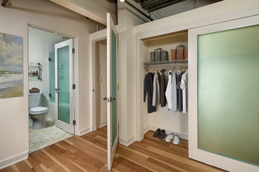 a walk in closet with a frosted glass door