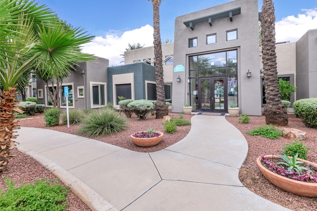 A modern building with a concrete walkway in front.