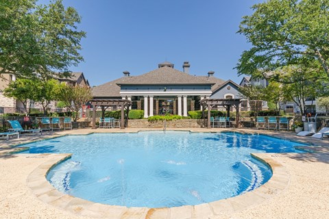 A large house with a pool in front.