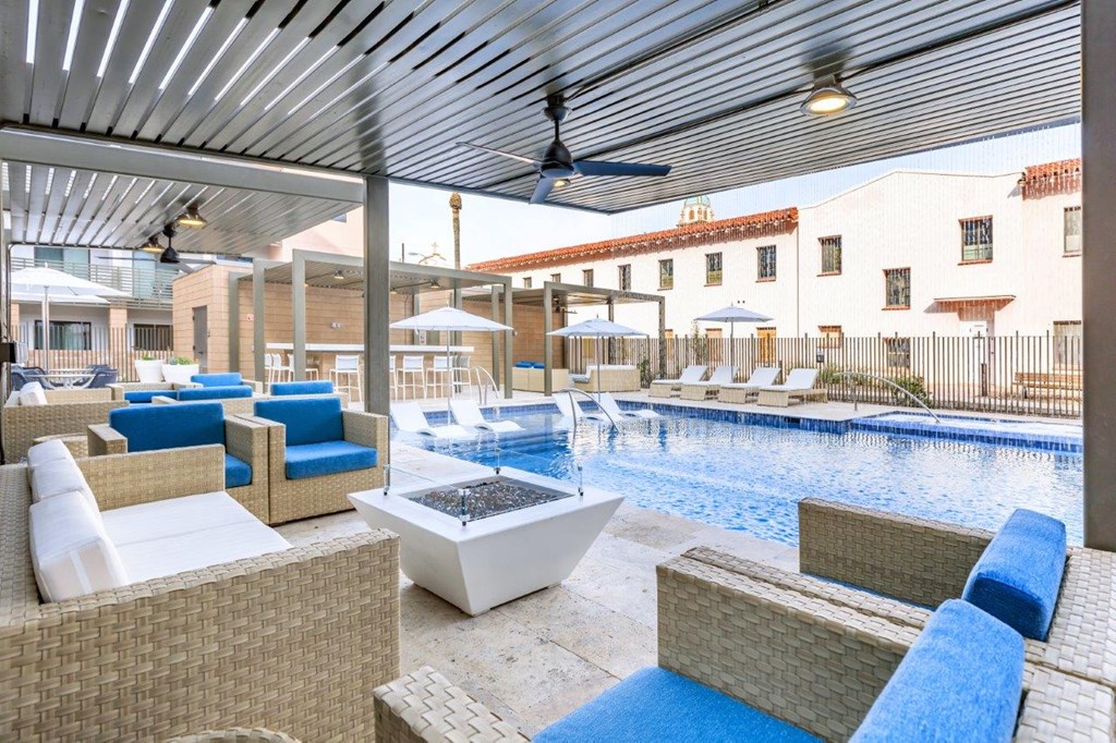 A patio with a pool and a ceiling fan.