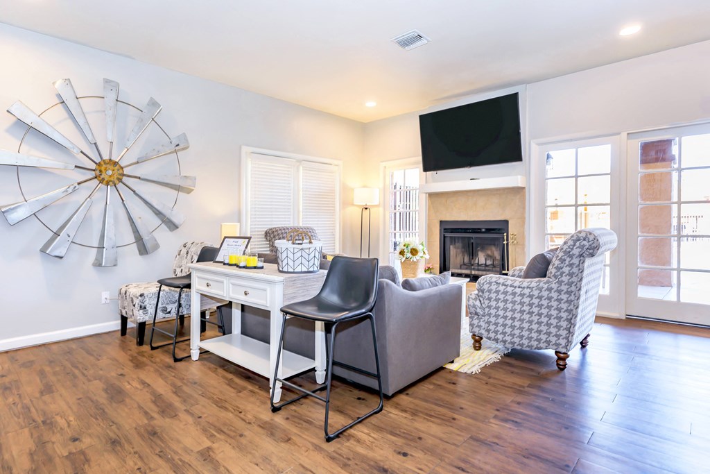 A living room with a white desk and a grey chair.