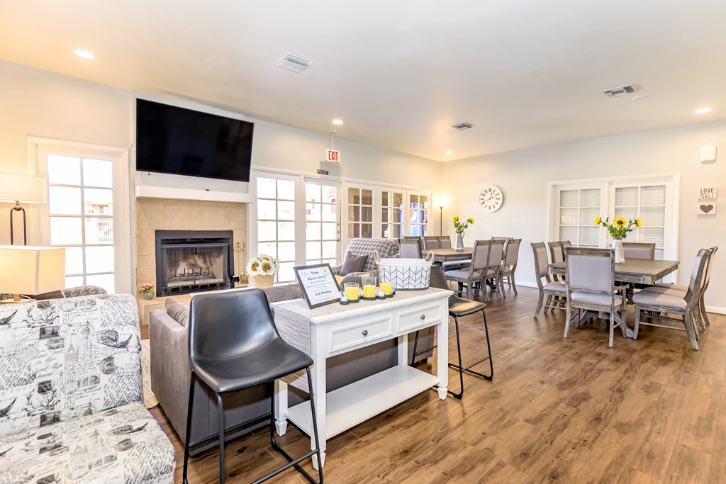 A living room with a fireplace and a television on the wall.
