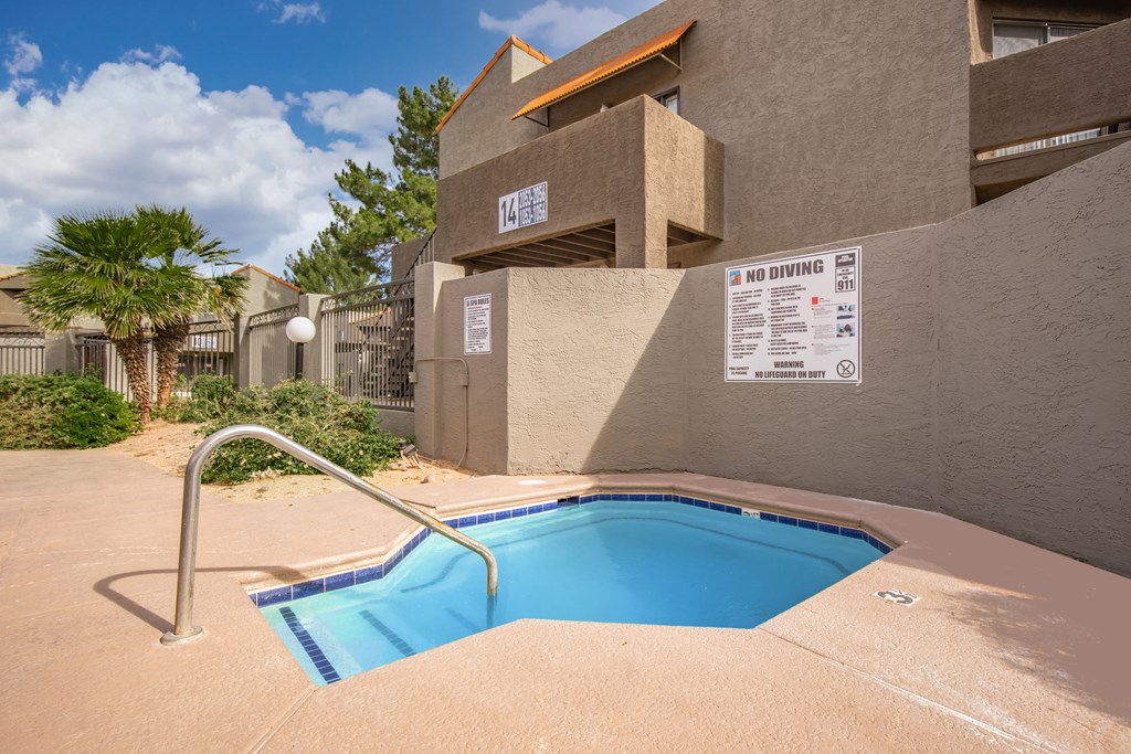 A pool in a concrete building with a sign that says "NO DIVING".