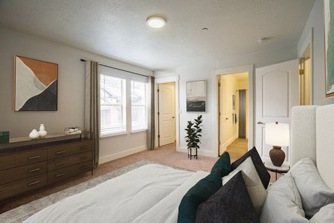 a bedroom with a bed and a dresser and a window