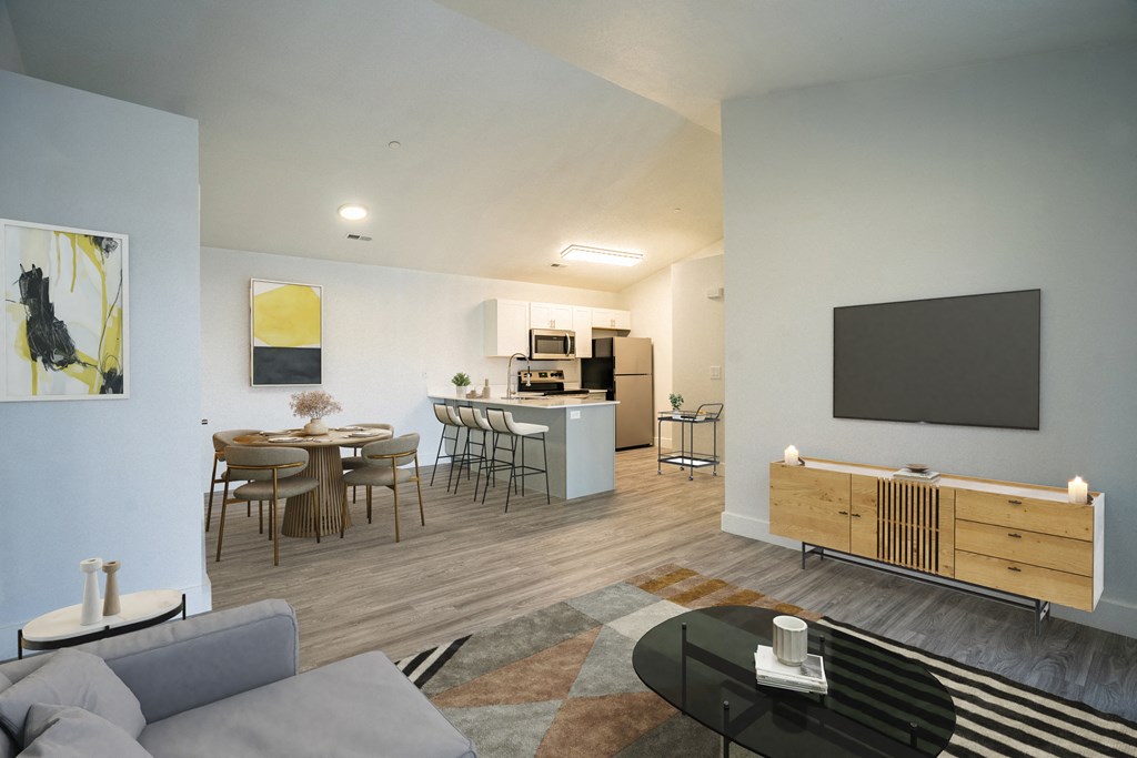 an open living room and kitchen area with a dining table and chairs