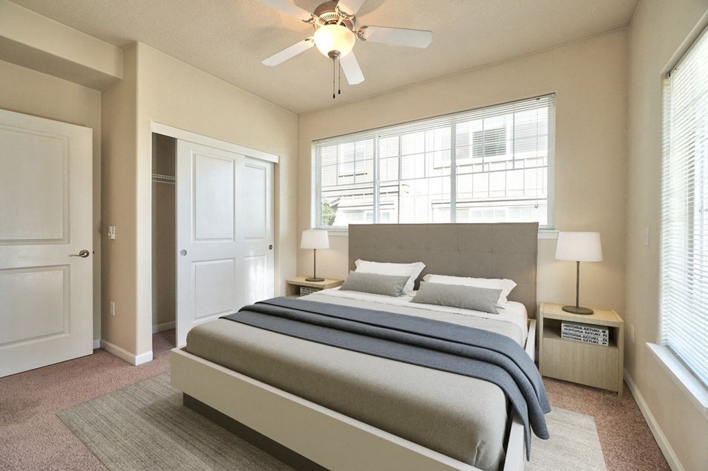a bedroom with a bed and a ceiling fan
