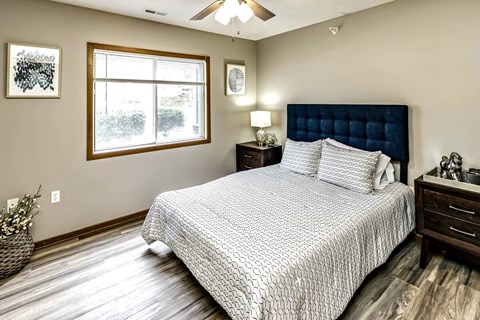 A bedroom with a large bed and a window.