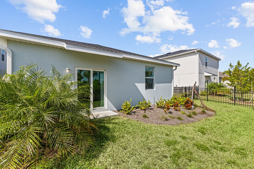 A house with a white exterior and a green lawn.