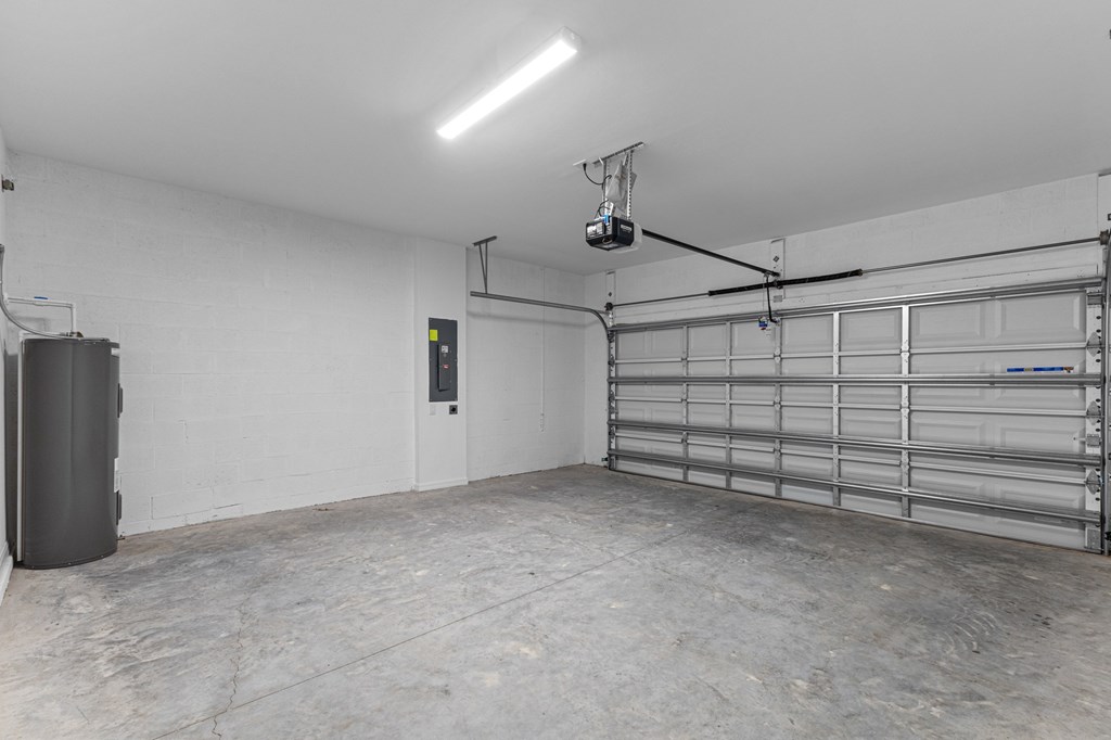 A garage with a white wall and a metal shelf.
