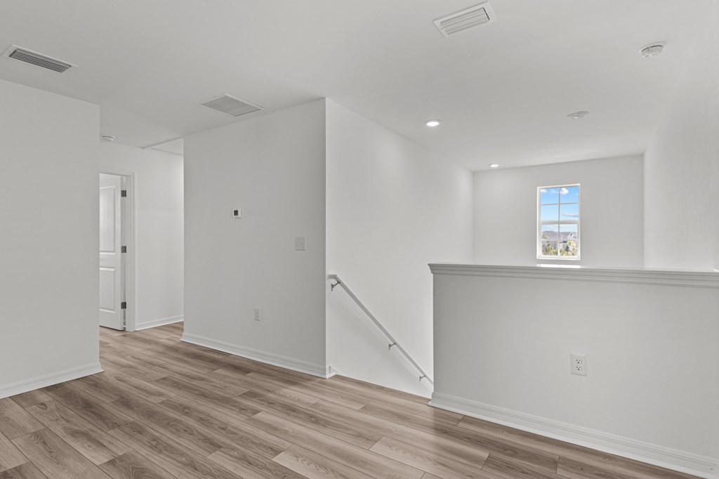 A room with wooden floors and white walls.
