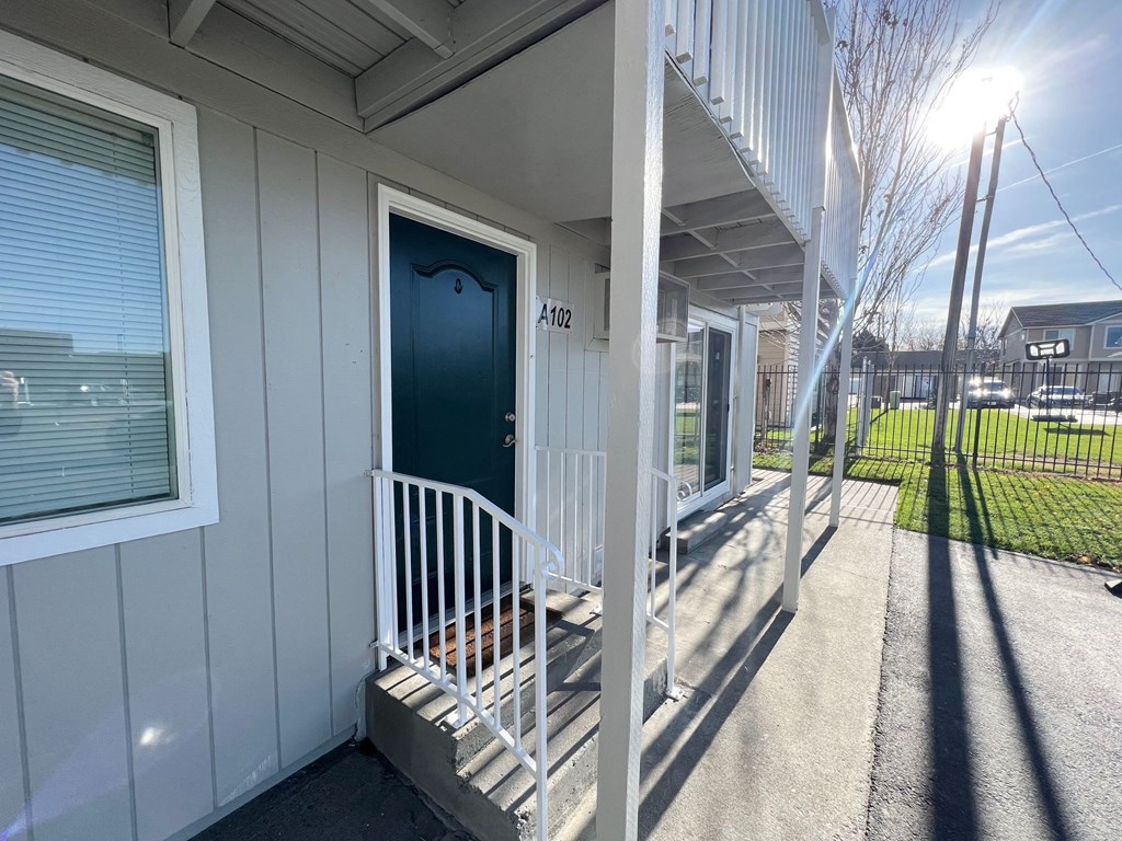 the front porch of a house with a blue door