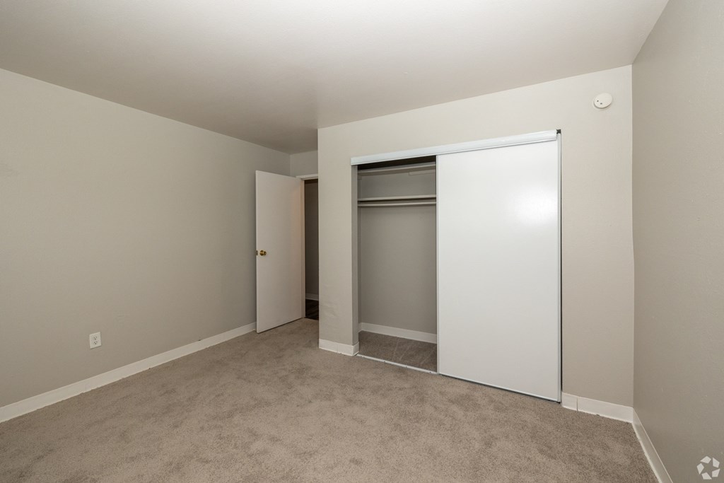 A room with a white door and a white wardrobe.