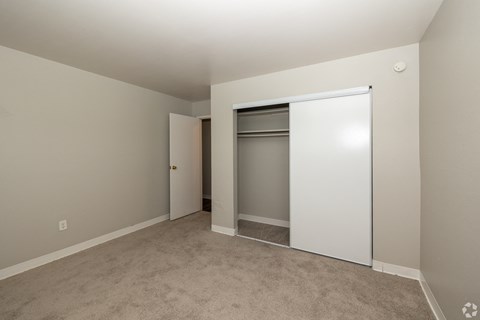 A room with a white door and a white wardrobe.