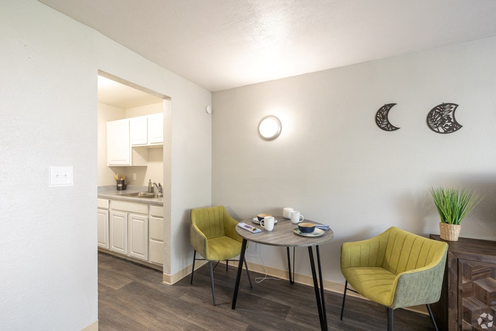 A small dining area with a table and two chairs.