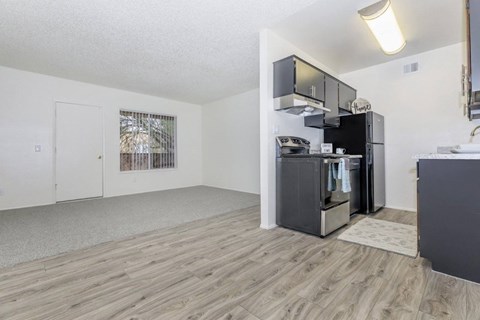 A kitchen area with a refrigerator, microwave, and oven.