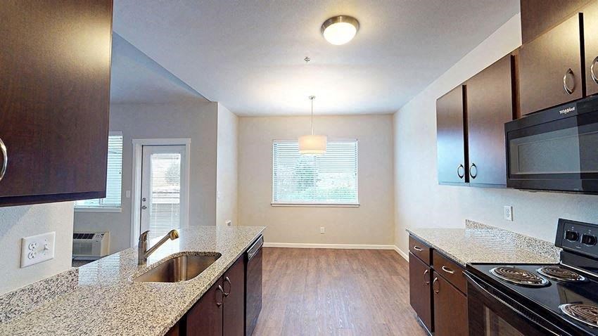 an empty kitchen with a sink and a stove