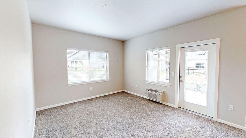 an empty room with a door and a window