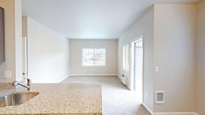 an empty room with a sink and a window