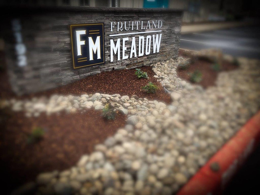 a wooden sign that says meadow
