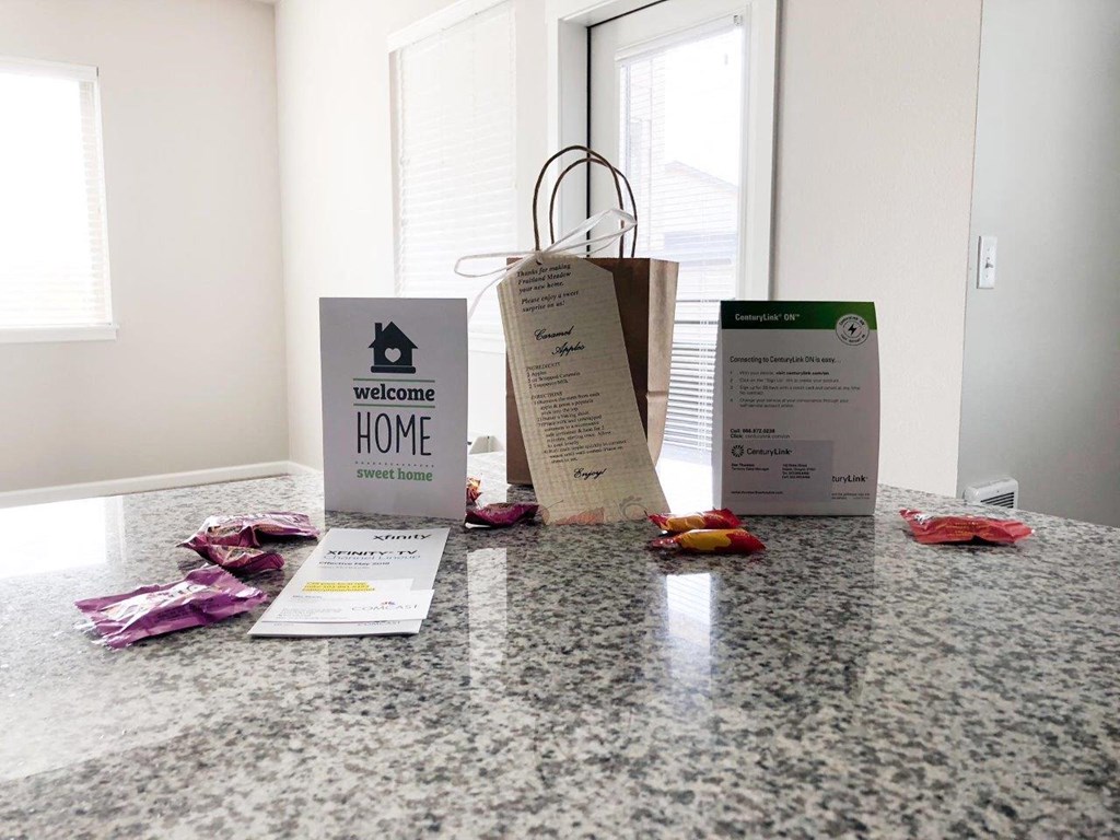 three bags sitting on a counter with some clothes on it
