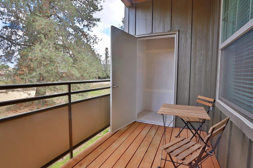 a balcony with a table and chairs on it