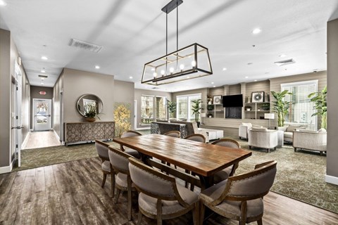 A modern dining room with a wooden table and chairs.